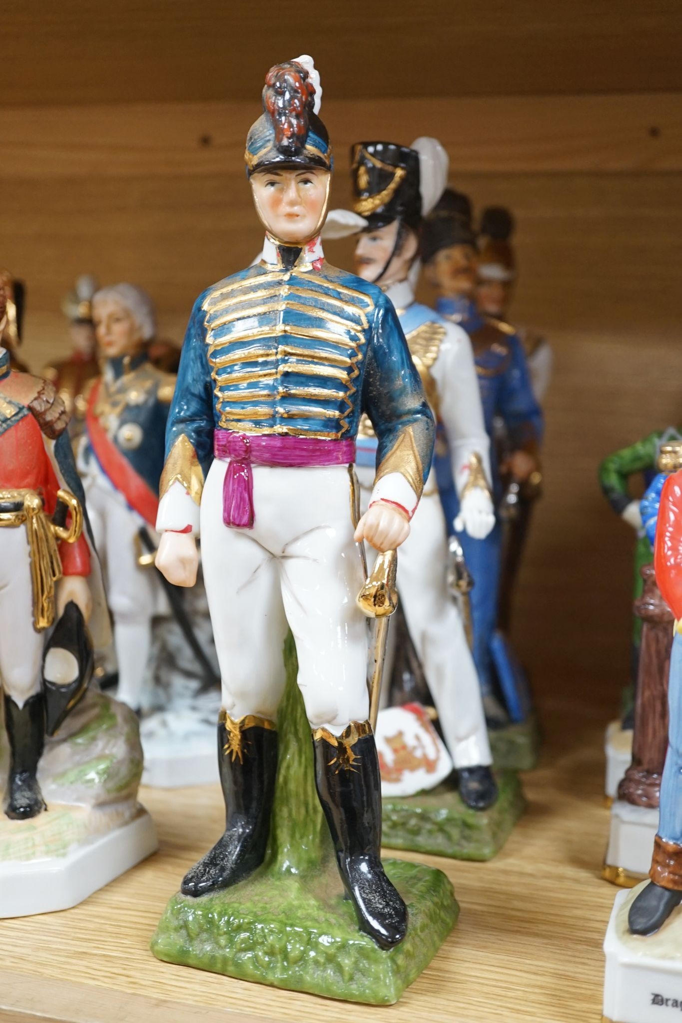 A collection of Continental porcelain figures of military soldiers, tallest 27.5cm